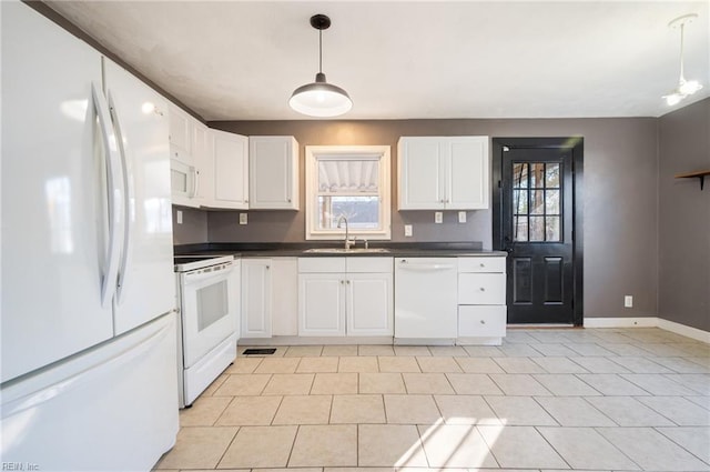 kitchen with dark countertops, white appliances, plenty of natural light, and a sink