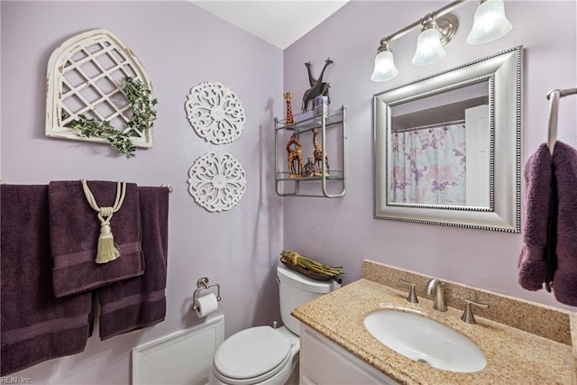 bathroom featuring toilet and vanity