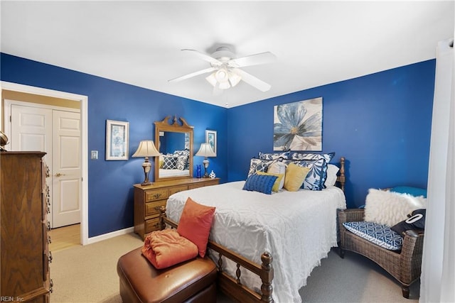 bedroom featuring ceiling fan, light colored carpet, and baseboards