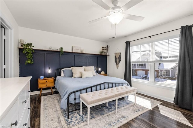 bedroom with dark wood-style flooring, ceiling fan, and baseboards