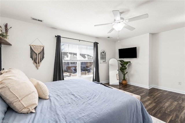 bedroom with a ceiling fan, baseboards, visible vents, and wood finished floors