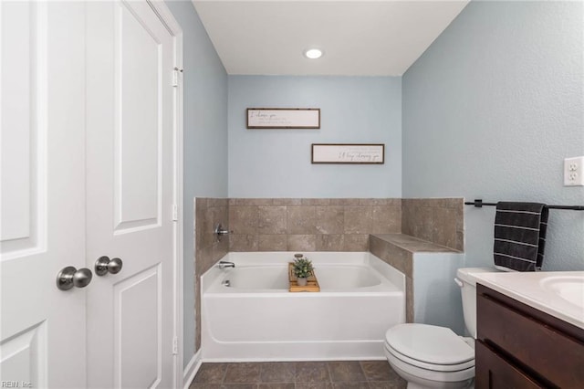 bathroom featuring toilet, a garden tub, and vanity