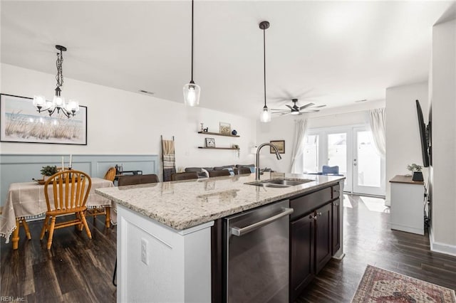 kitchen with decorative light fixtures, dark wood-type flooring, open floor plan, a sink, and dishwasher