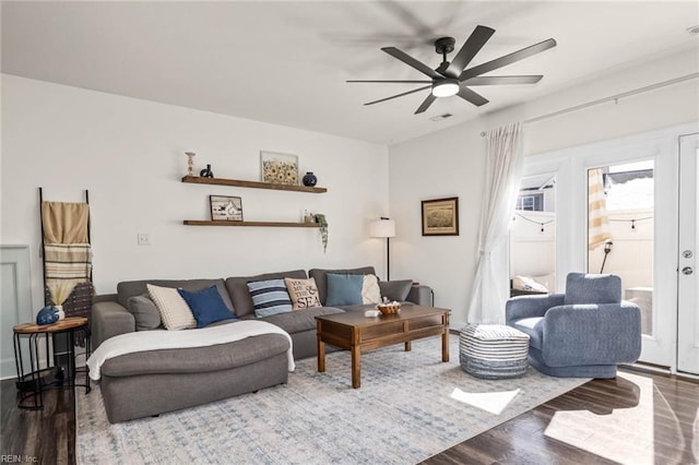 living room with a ceiling fan and wood finished floors