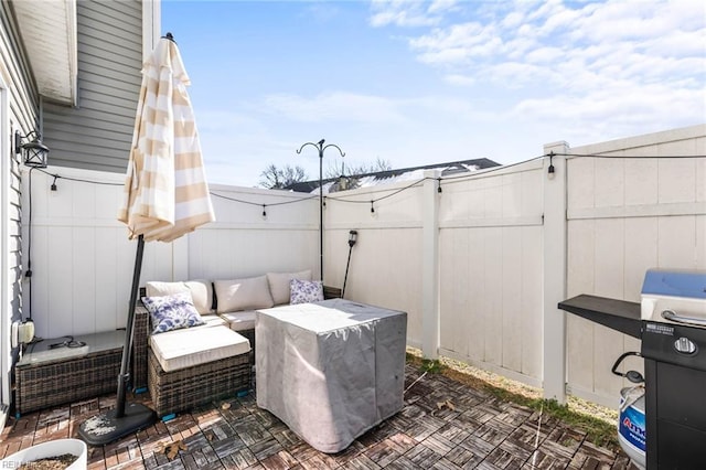 view of patio featuring fence and an outdoor hangout area