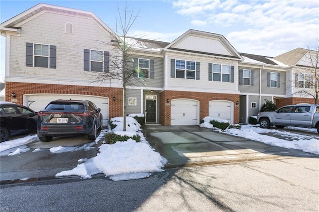 view of front of house with concrete driveway, brick siding, and an attached garage