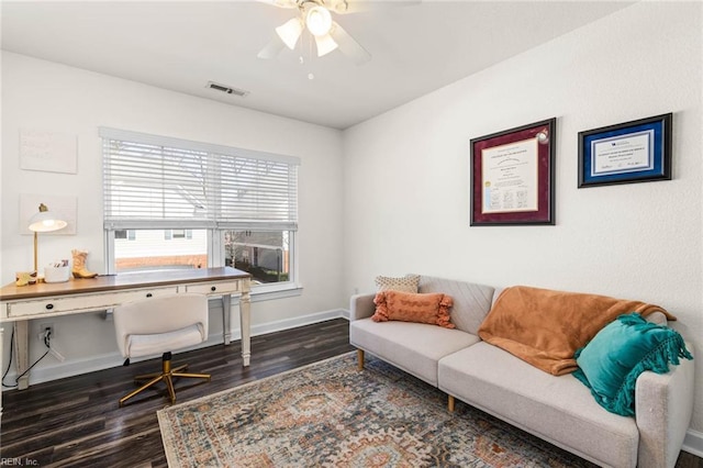 office area with a ceiling fan, wood finished floors, visible vents, and baseboards