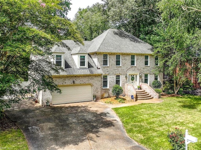 colonial house featuring driveway, a garage, roof with shingles, a front lawn, and brick siding