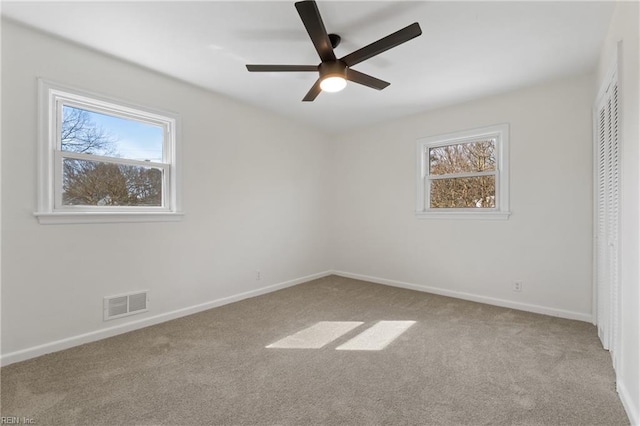 unfurnished bedroom featuring a closet, carpet, visible vents, and baseboards