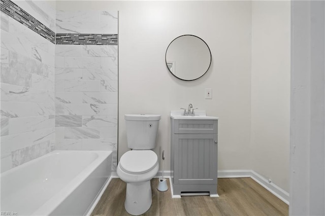 full bathroom featuring toilet, baseboards, wood finished floors, and vanity