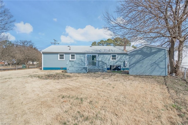 rear view of property with an outbuilding, a shed, and a lawn