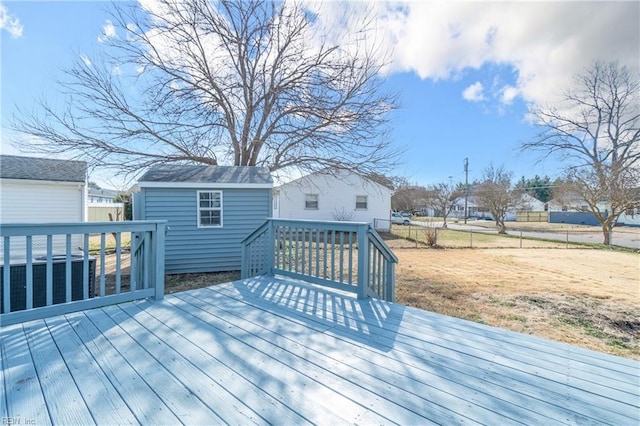 wooden deck featuring an outbuilding and cooling unit