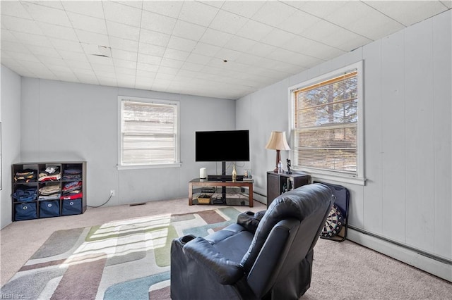 living room with light carpet and baseboard heating