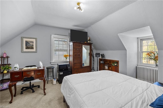 bedroom featuring vaulted ceiling, radiator heating unit, and light colored carpet