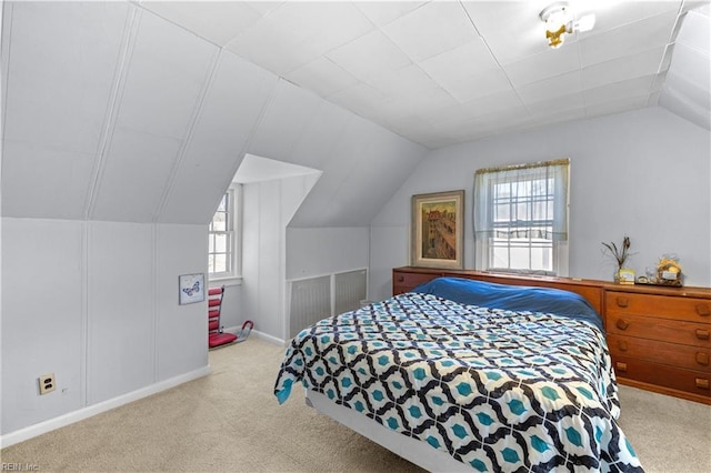 bedroom featuring lofted ceiling and light carpet