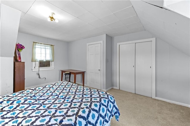 bedroom with light carpet, a closet, vaulted ceiling, and cooling unit