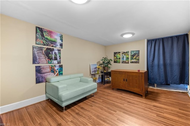 sitting room featuring light wood finished floors and baseboards