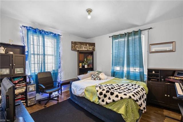 bedroom with dark wood finished floors