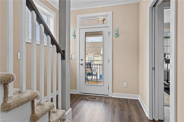 foyer entrance with visible vents, stairs, baseboards, and dark wood finished floors