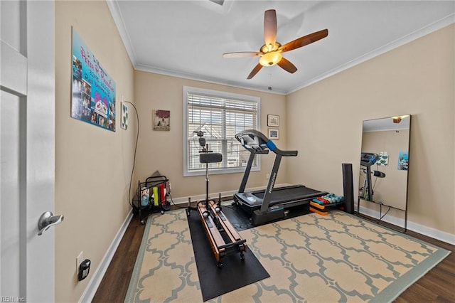 workout area featuring a ceiling fan, crown molding, baseboards, and wood finished floors