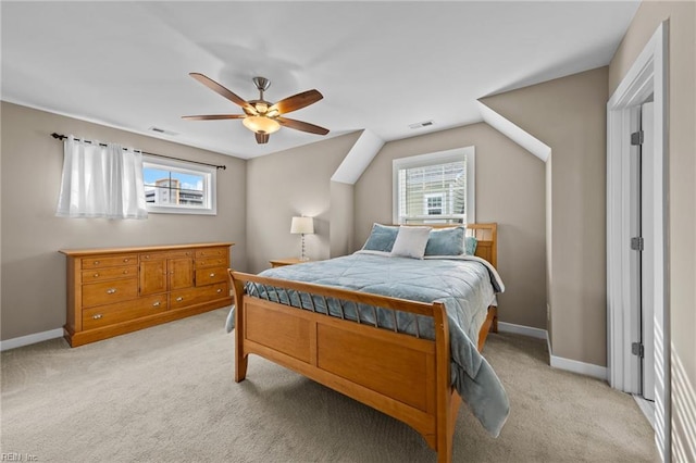 bedroom featuring multiple windows, baseboards, and light colored carpet