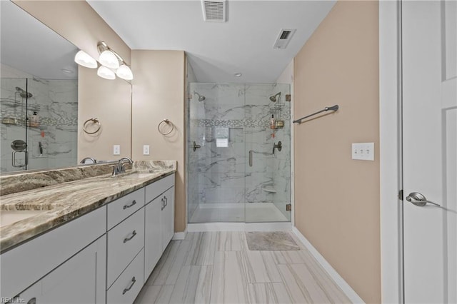 bathroom featuring double vanity, a marble finish shower, a sink, and visible vents