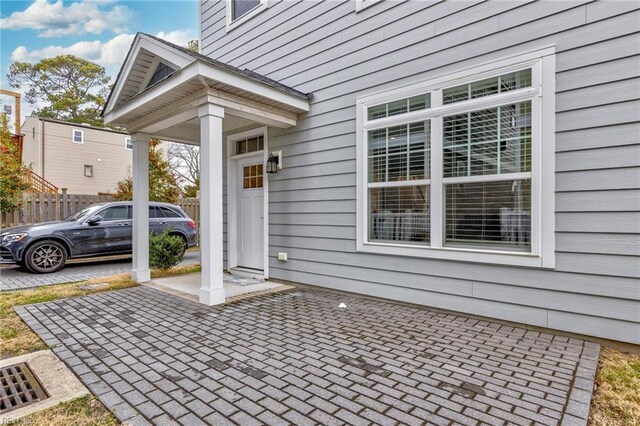 doorway to property featuring fence