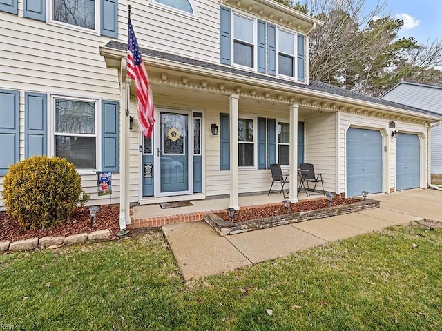 view of front of property featuring a garage, concrete driveway, and a porch