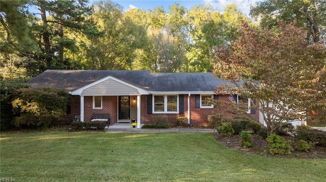 single story home featuring brick siding and a front yard