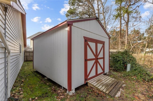 view of shed featuring fence