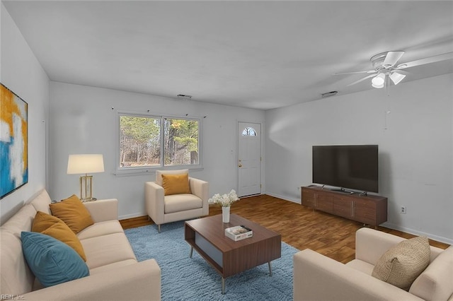 living room with baseboards and wood finished floors