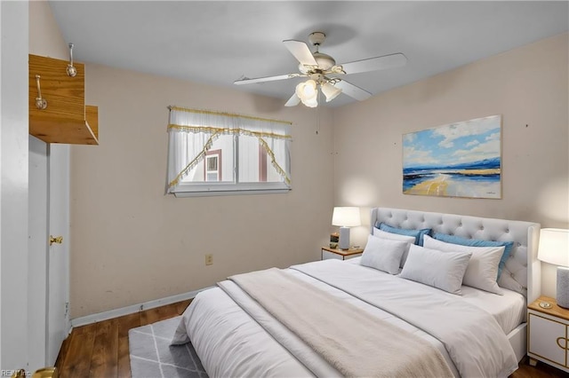 bedroom featuring ceiling fan, wood finished floors, and baseboards