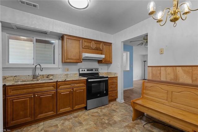 kitchen featuring stainless steel electric range oven, visible vents, a sink, light stone countertops, and under cabinet range hood