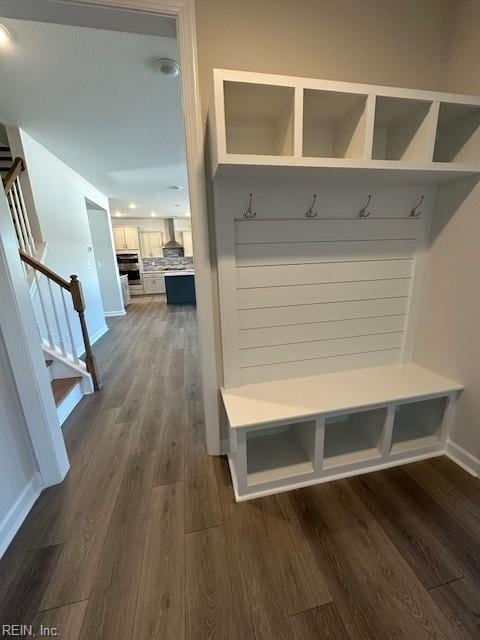 mudroom with dark wood-type flooring and baseboards