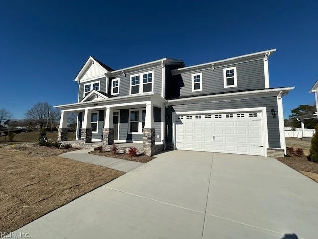 view of front of property with a garage, covered porch, and driveway