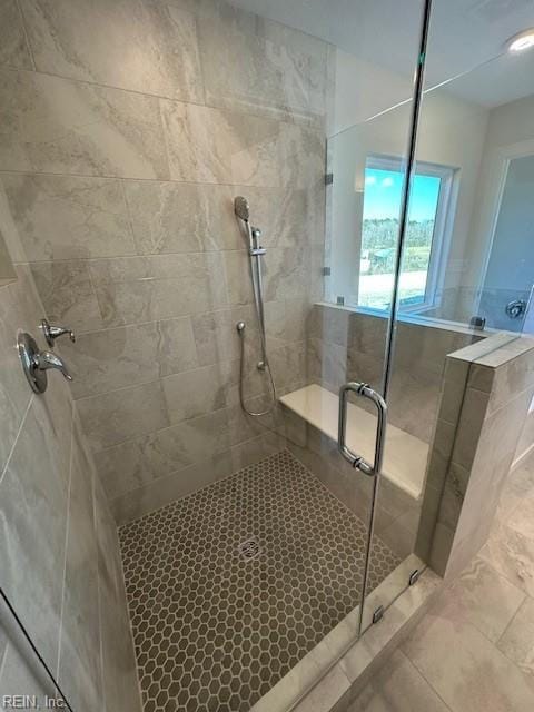 full bathroom with a stall shower and tile patterned flooring