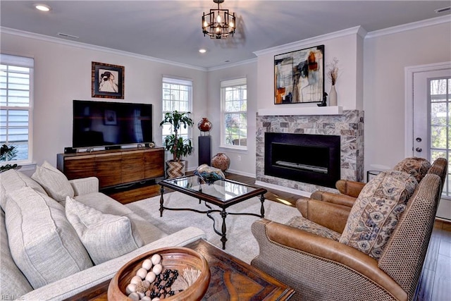 living area featuring a stone fireplace, visible vents, wood finished floors, and ornamental molding