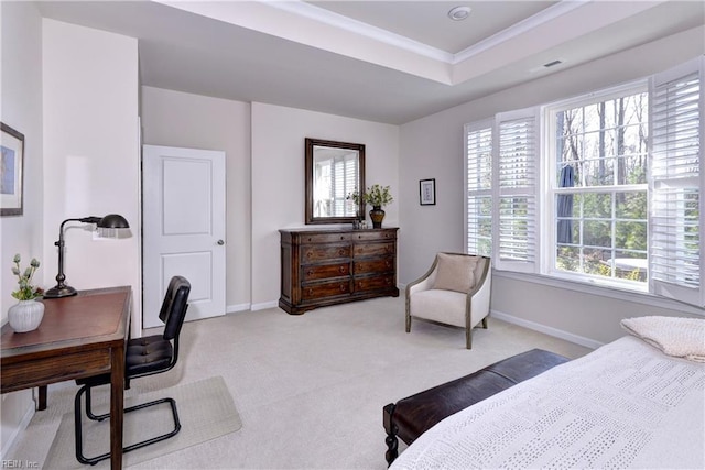 bedroom featuring ornamental molding, a tray ceiling, light colored carpet, and baseboards