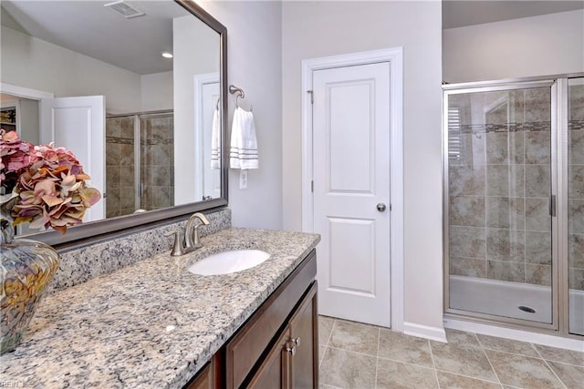 full bathroom with a stall shower, visible vents, vanity, and tile patterned floors