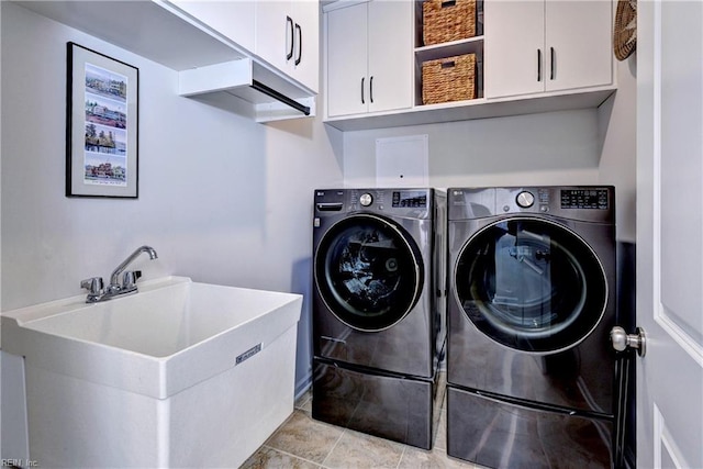 clothes washing area featuring cabinet space, light tile patterned floors, a sink, and independent washer and dryer