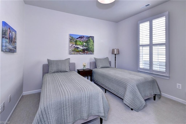 carpeted bedroom with visible vents and baseboards