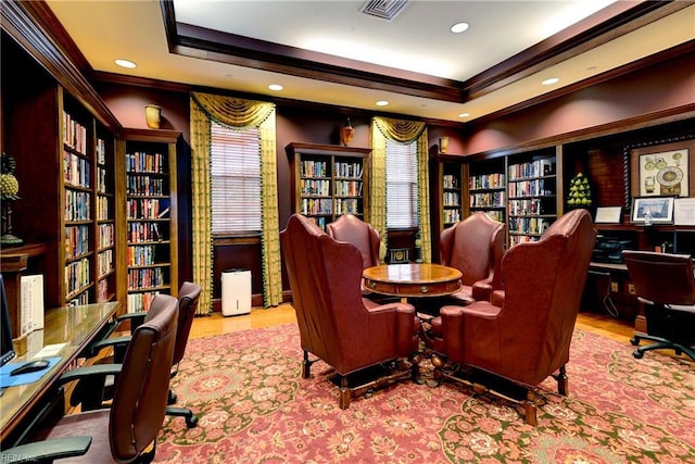 office area featuring visible vents, ornamental molding, wall of books, a tray ceiling, and recessed lighting