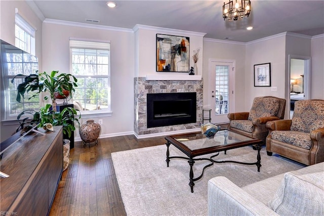 living room featuring plenty of natural light, visible vents, and crown molding