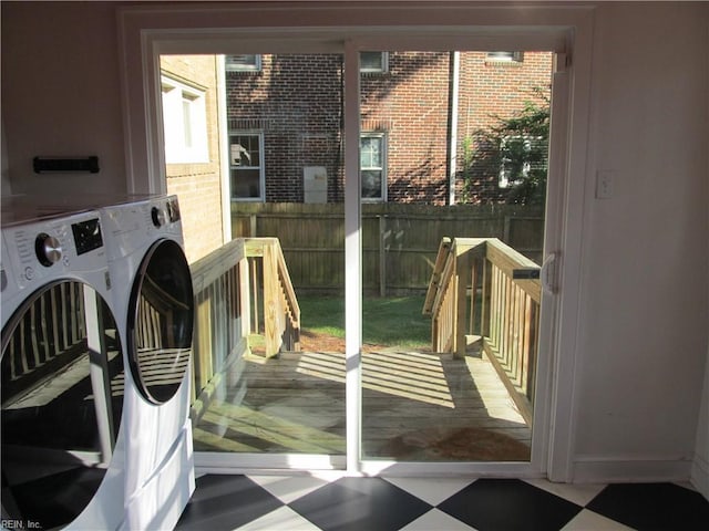 doorway with washer / dryer and tile patterned floors