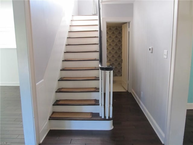 stairs with baseboards and wood finished floors