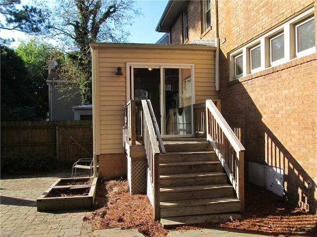 entrance to property featuring fence