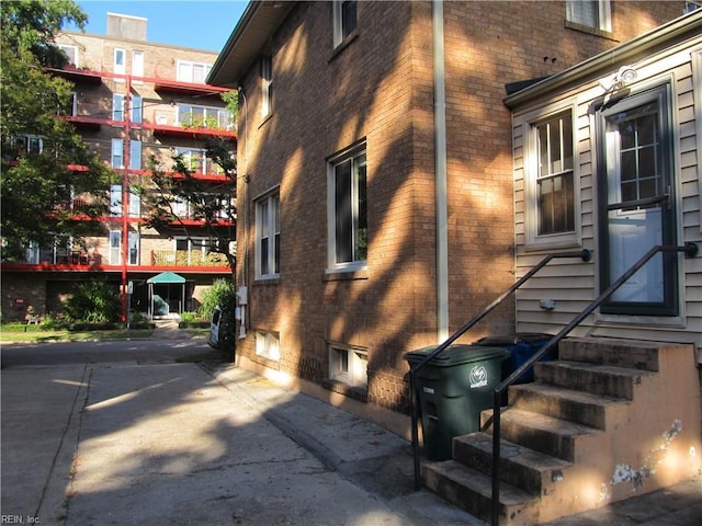 view of side of property featuring entry steps and brick siding