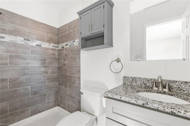 full bath featuring a shower stall, vanity, and toilet