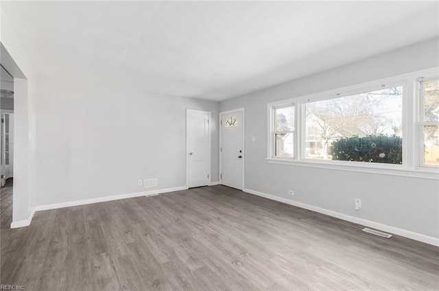 interior space with plenty of natural light, visible vents, and baseboards