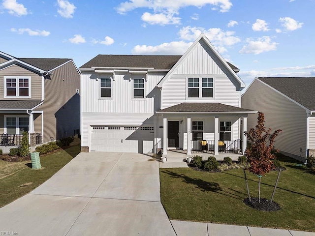 view of front of property with driveway, a garage, covered porch, board and batten siding, and a front yard